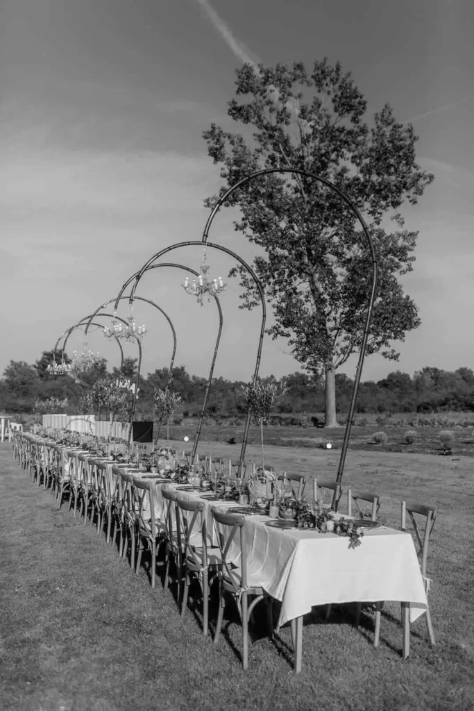 Long outdoor banquet table setup for a private event by Catering Majetic