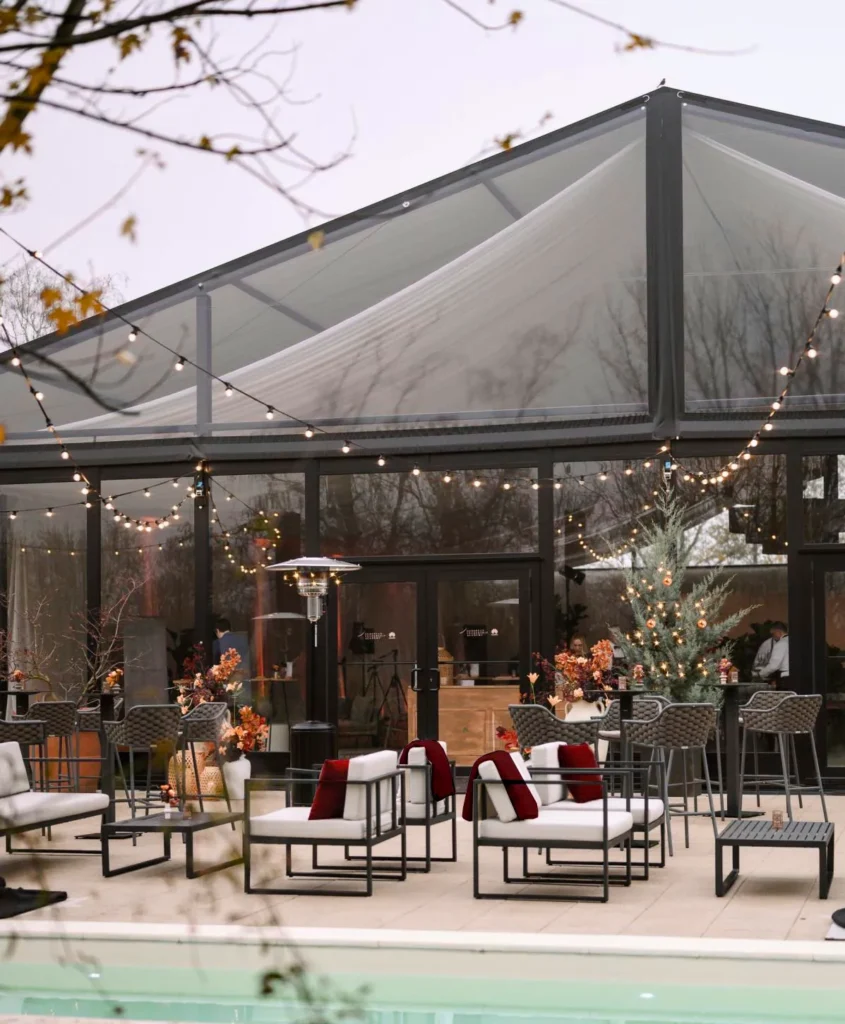 Elegant outdoor winter event setup with transparent marquee and lounge seating