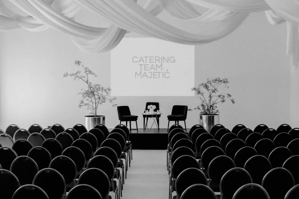 Conference venue setup with stage and seating prepared by Catering Majetic