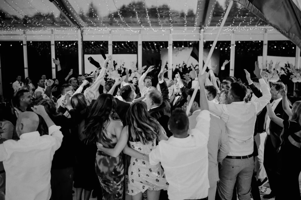 Wedding celebration in Croatia with guests dancing under lights in a marquee tent