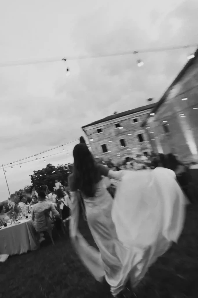 Bride walking across a garden wedding reception in Croatia during an outdoor celebration