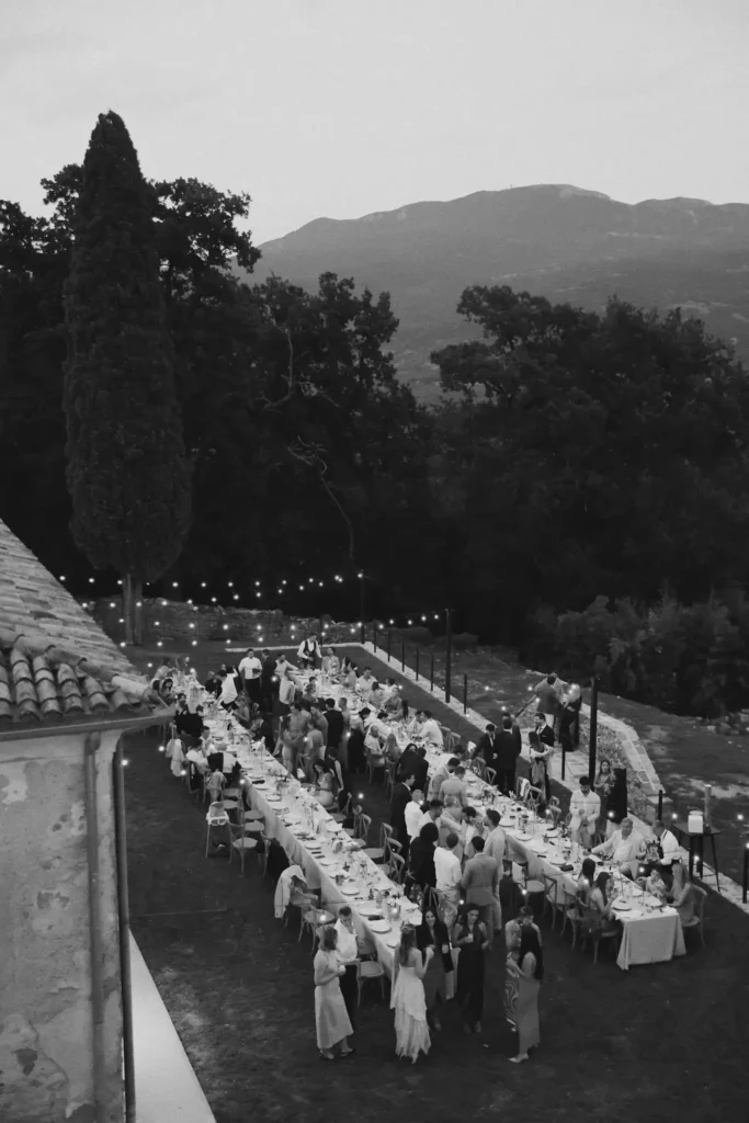 Artistic black and white overhead view of a long wedding banquet table at Castle Belaj, with professional event setup by Catering Majetic.