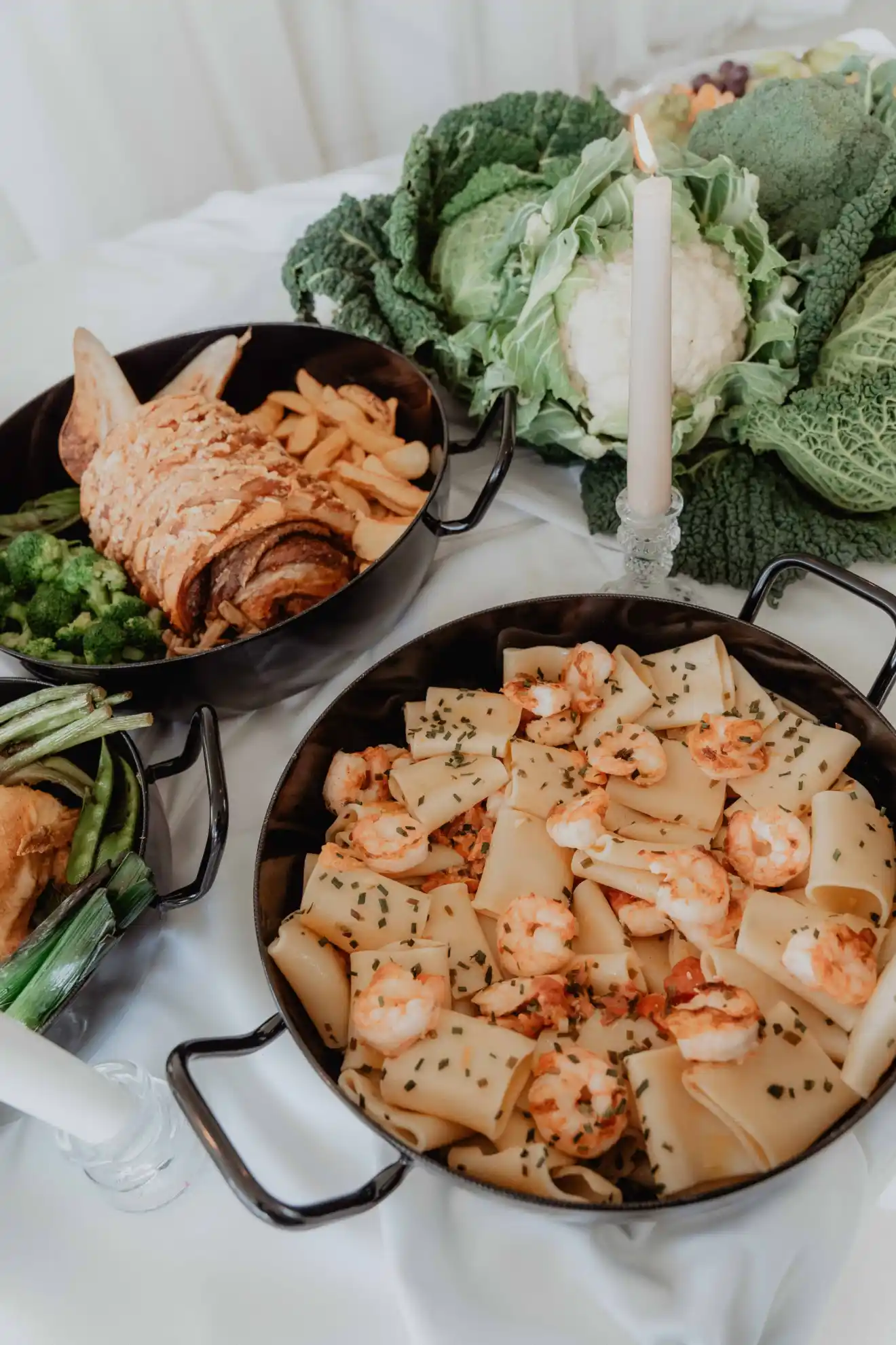 Delicious gourmet shrimp pasta served in a stylish black pan, prepared by Catering Majetic for a wedding banquet.