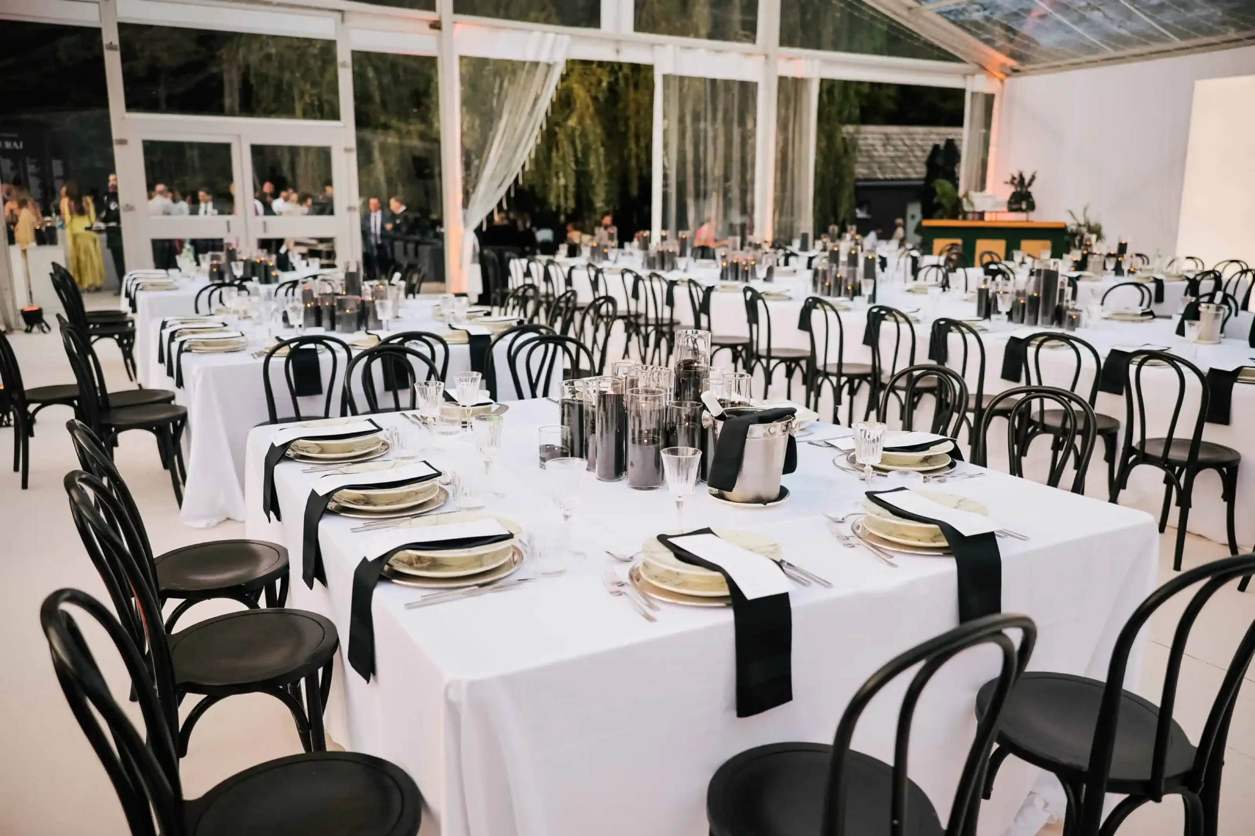 Elegant black and white wedding table setting inside a luxury marquee tent at Trakoscan Castle, with professional service by Catering Majetic